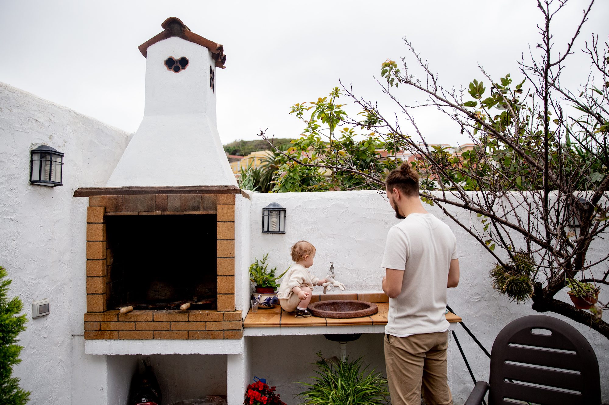 man and little boy in summer kitchen outside