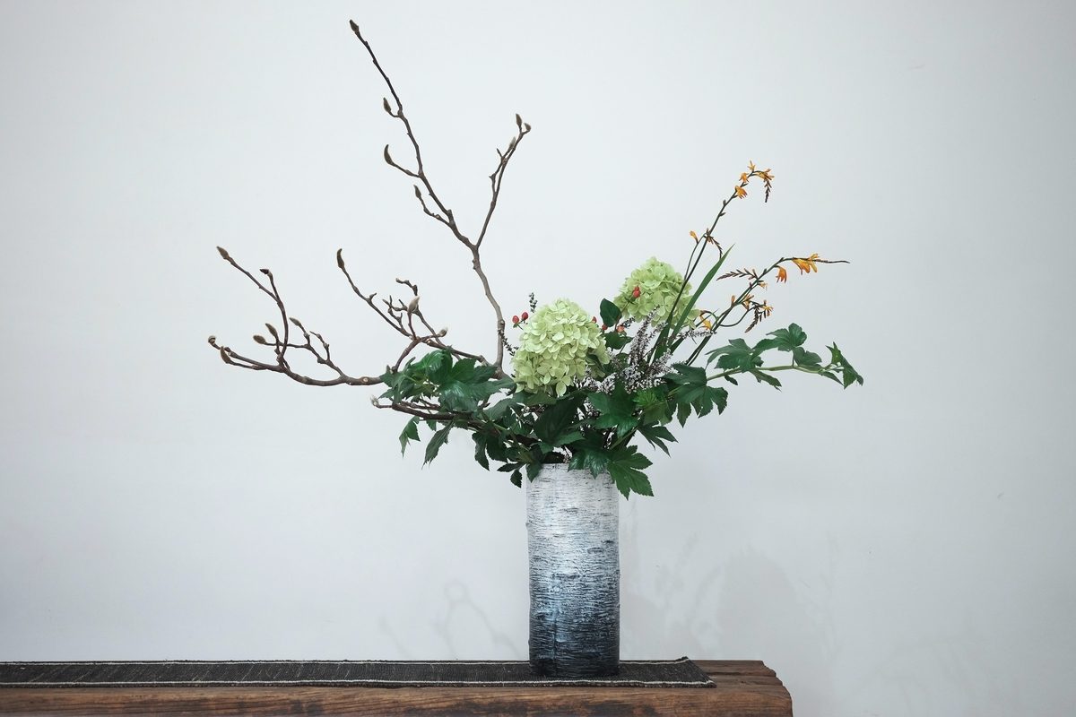 Flower arrangement in blue vase