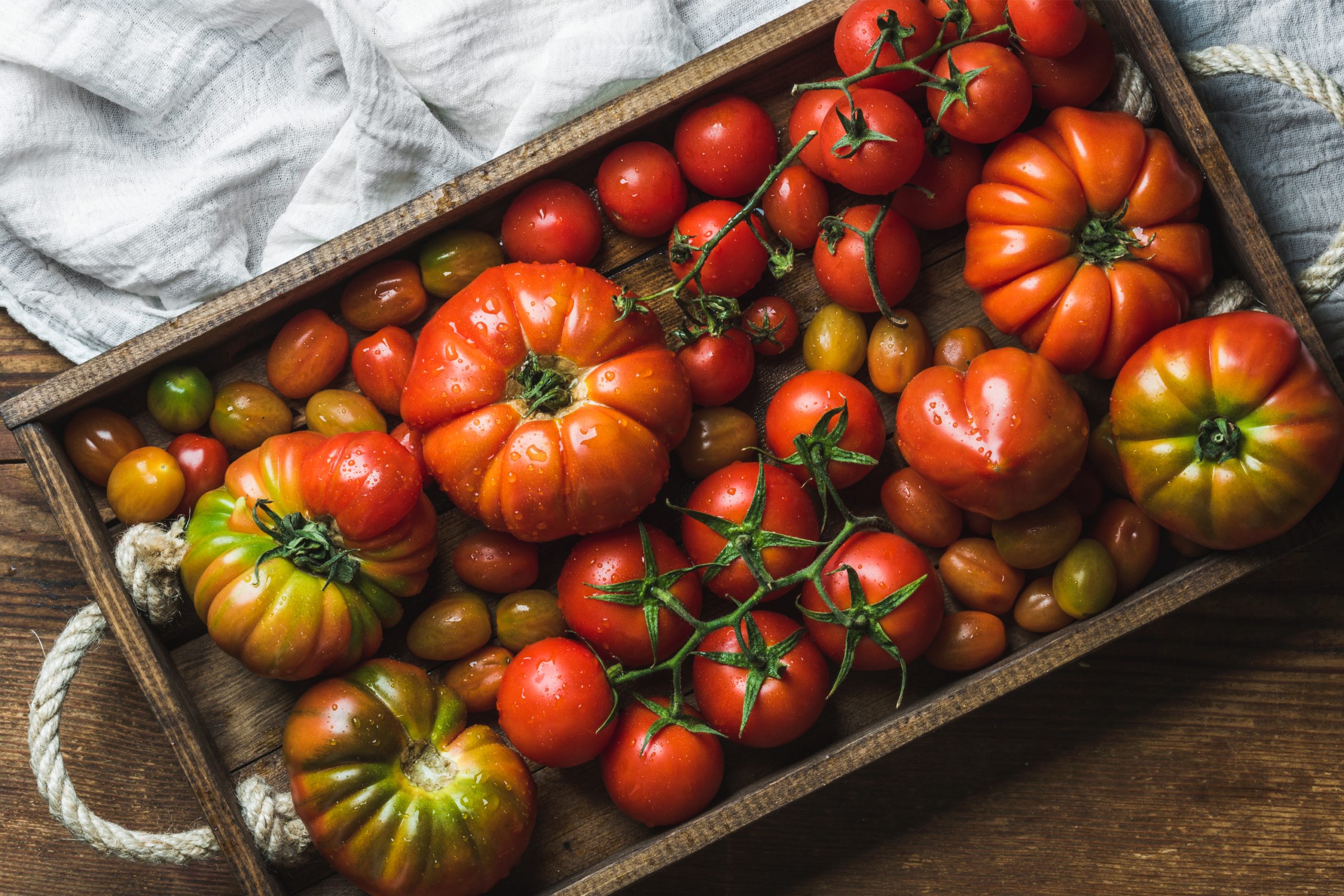 fresh tomatoes in a wooden crate