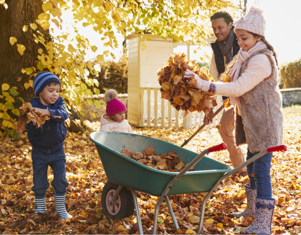 Family collecting fallen leaves