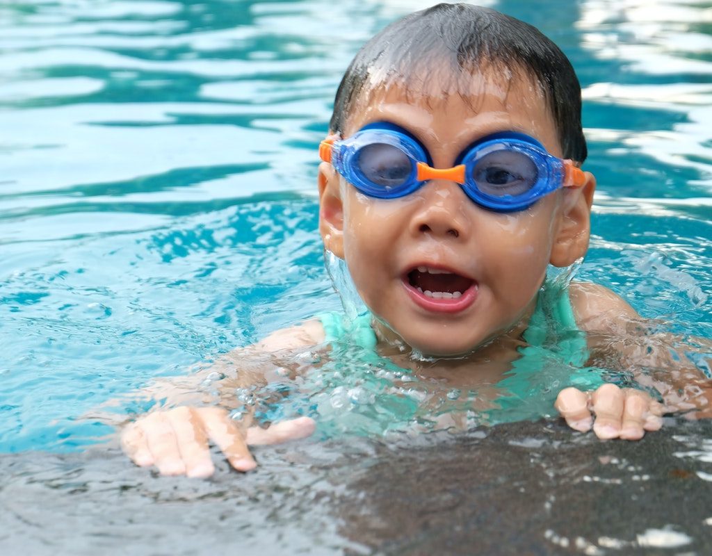A toddler swimming in a pool