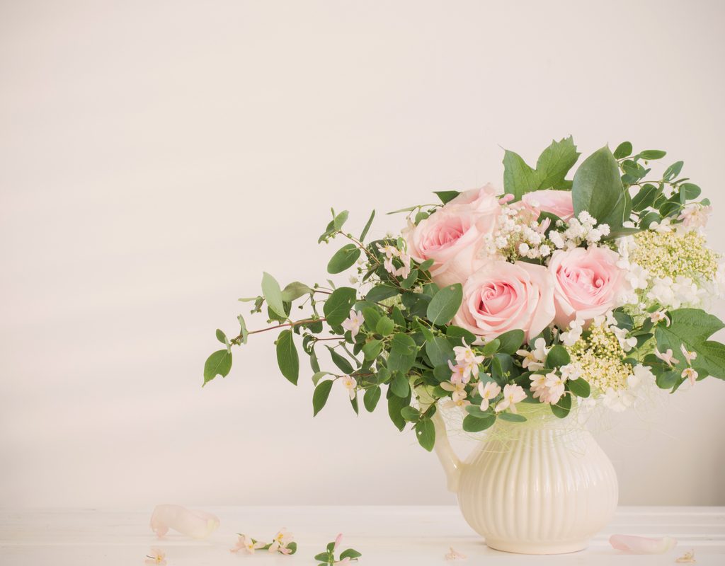 An arrangement of light roses and greenery