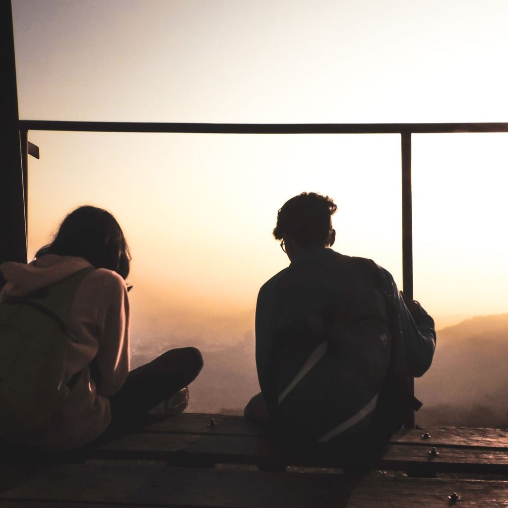 Two Persons Sitting On Deck in Evening