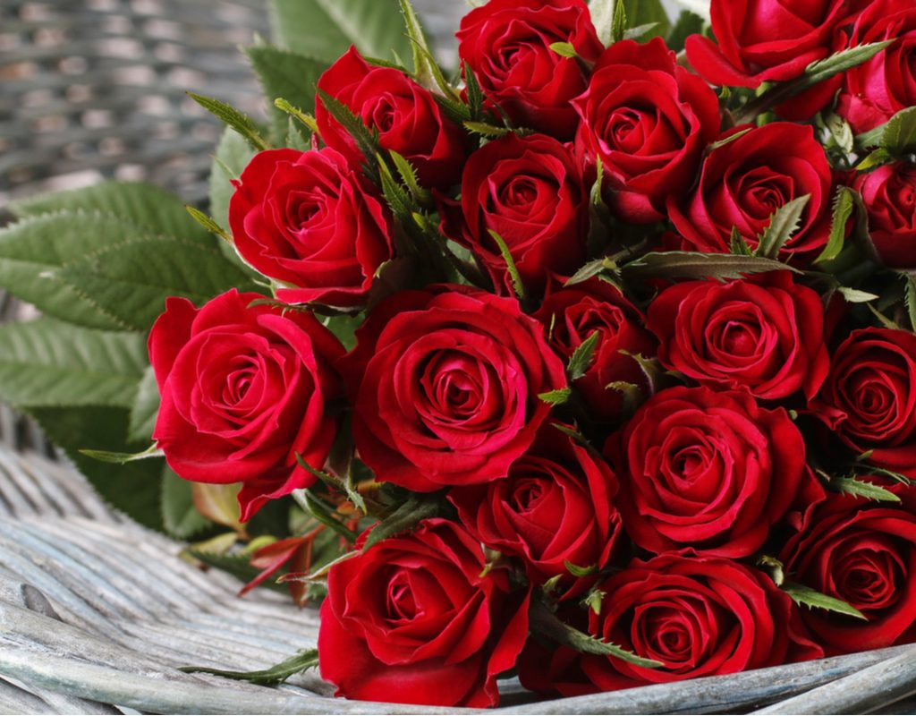 A beautiful red rose bouquet in a wicker basket