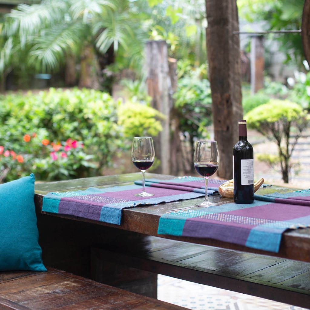 Wine Bottle and Glasses on Purple Mat