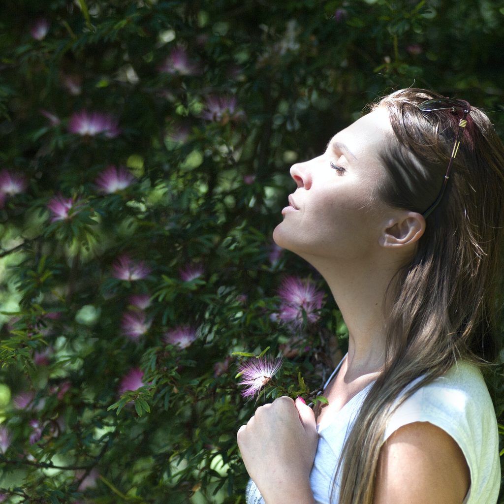Woman Closing Her Eyes Against Sun Light