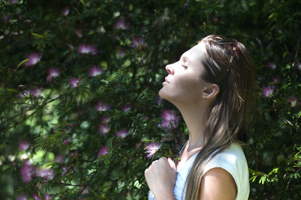 Woman Closing Her Eyes Against Sun Light