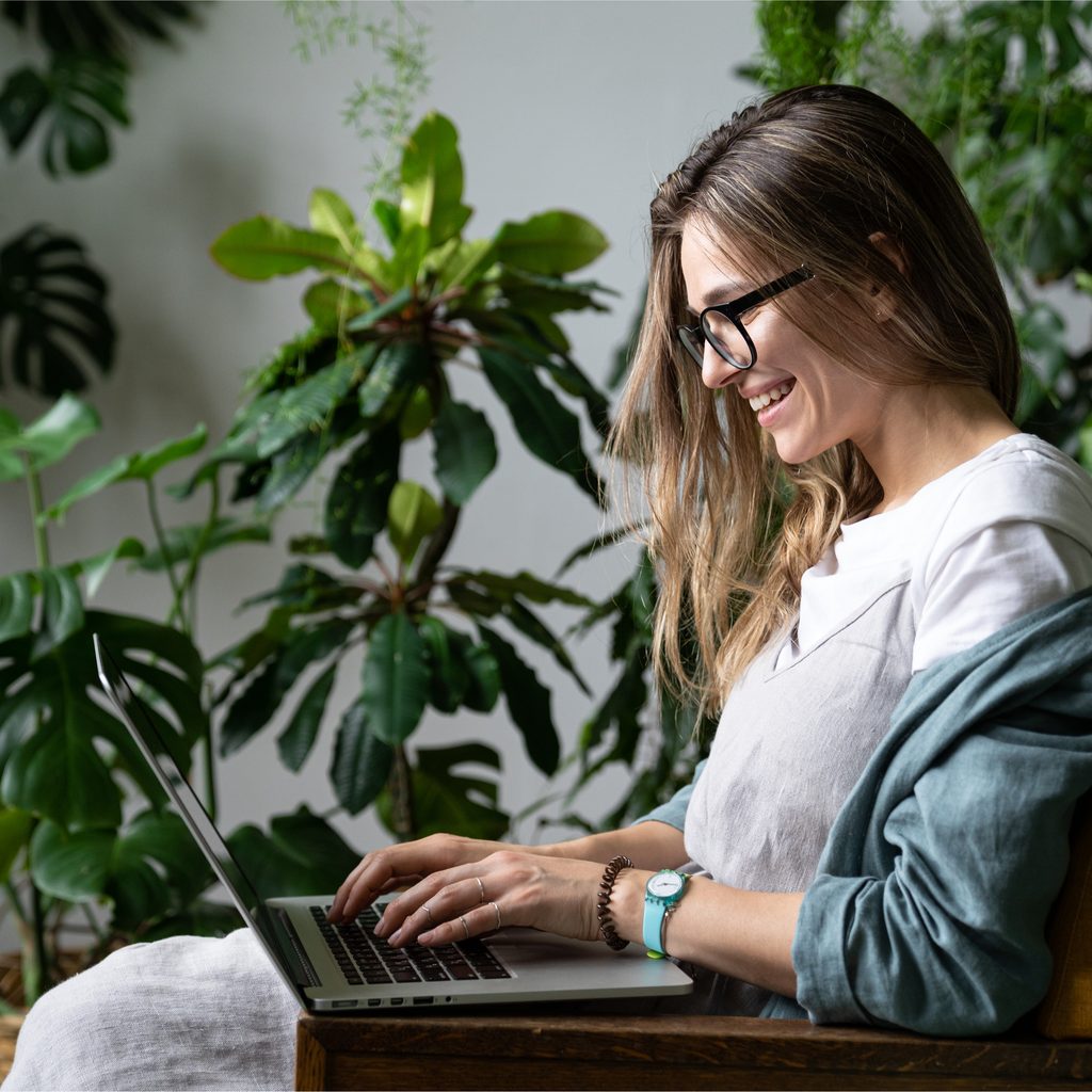 Person working on computer in garden