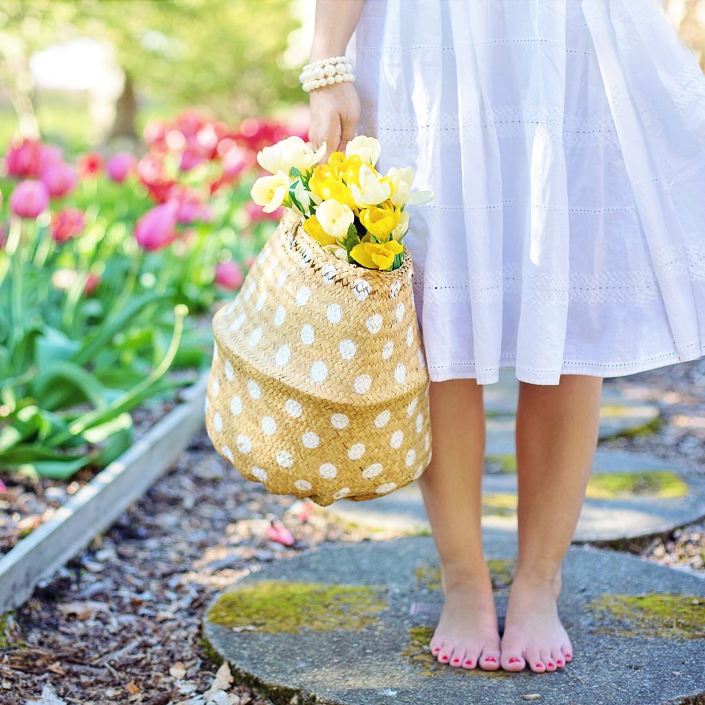 Woman Holding Brown Basket With Yellow Flowers