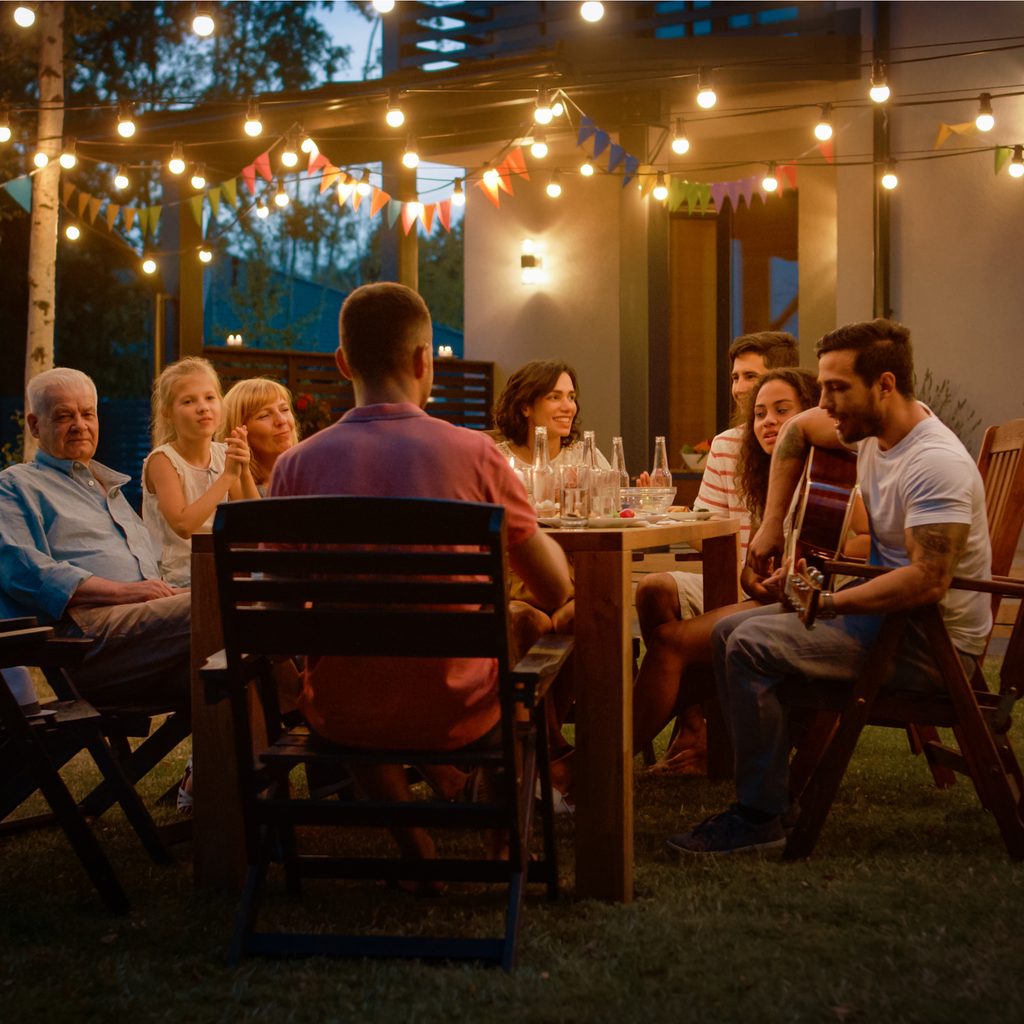 Group sitting at outdoor table at night