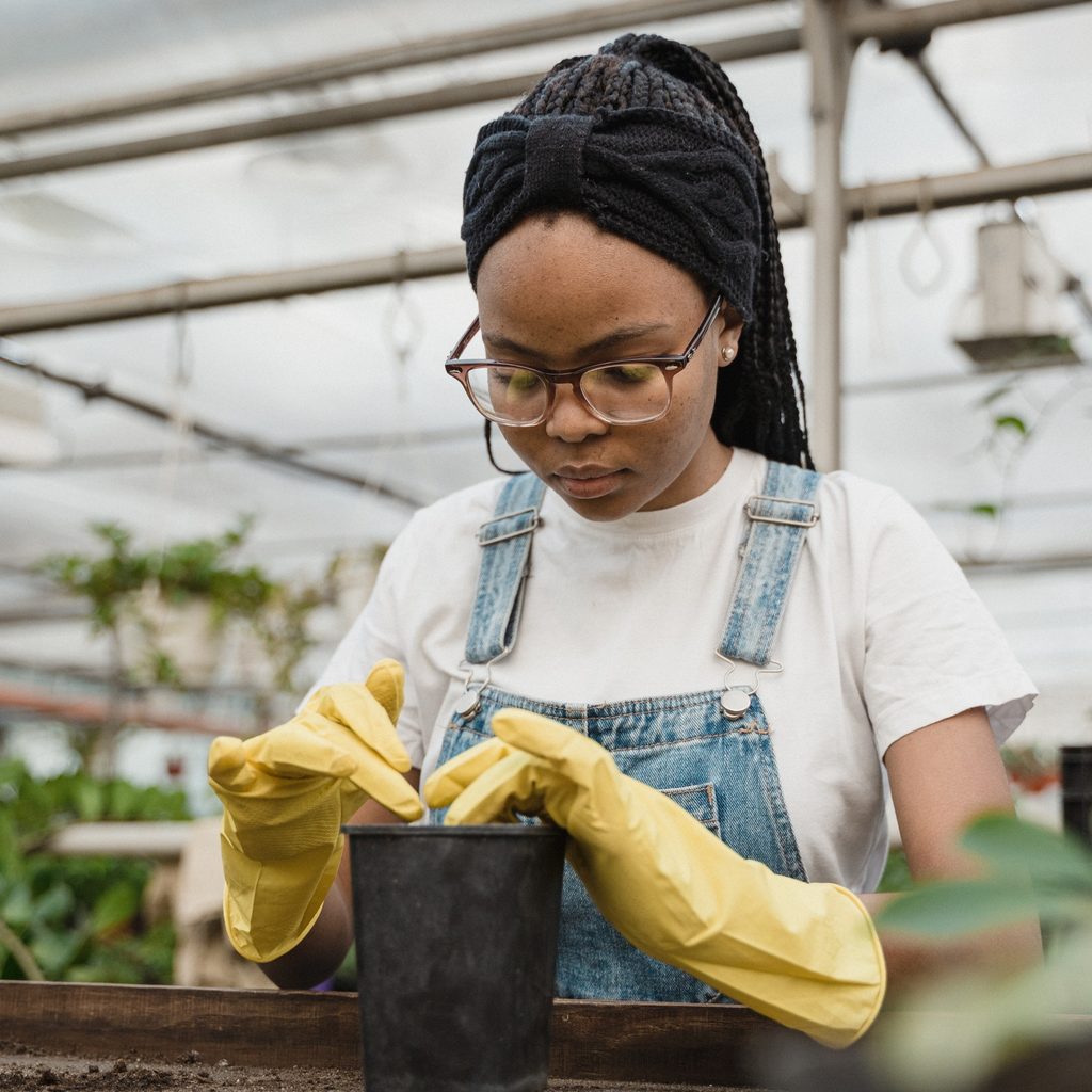 Woman putting soil in a pot