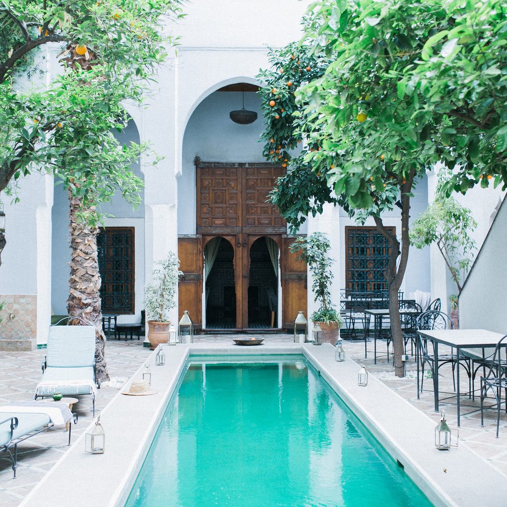 Chaise lounge chairs next to swimming pool
