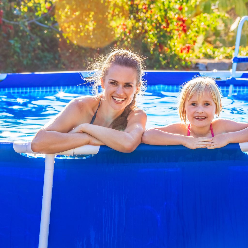 Mom and daughter enjoying above-ground pool