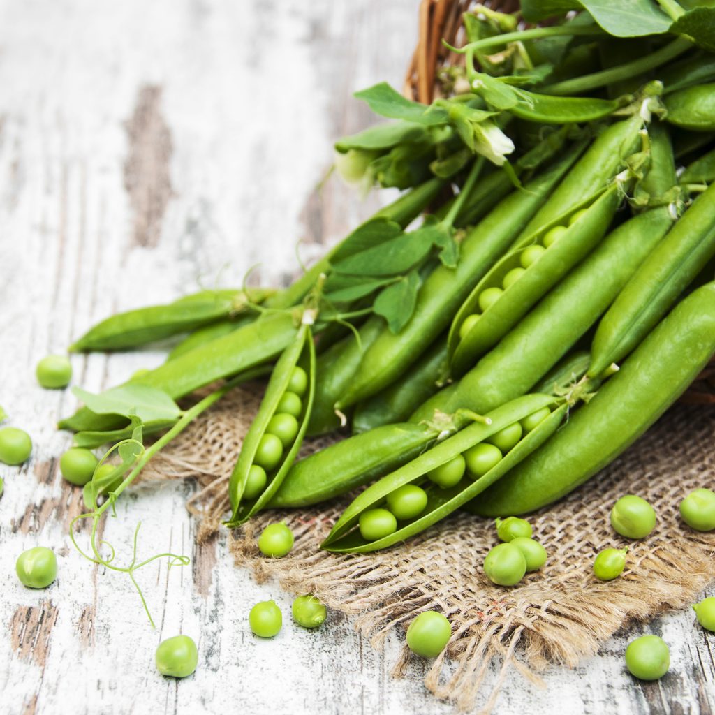 Green sugar snap peas on table