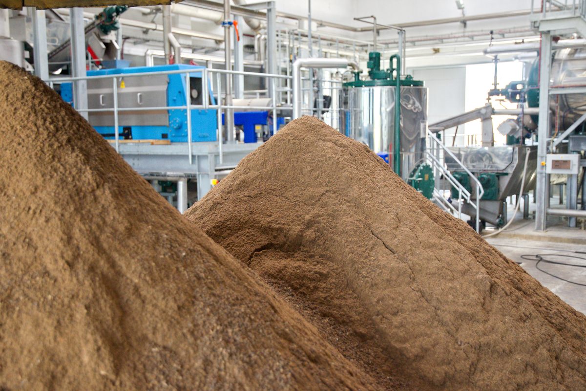 A pile of bone meal next to the equipment used to make it