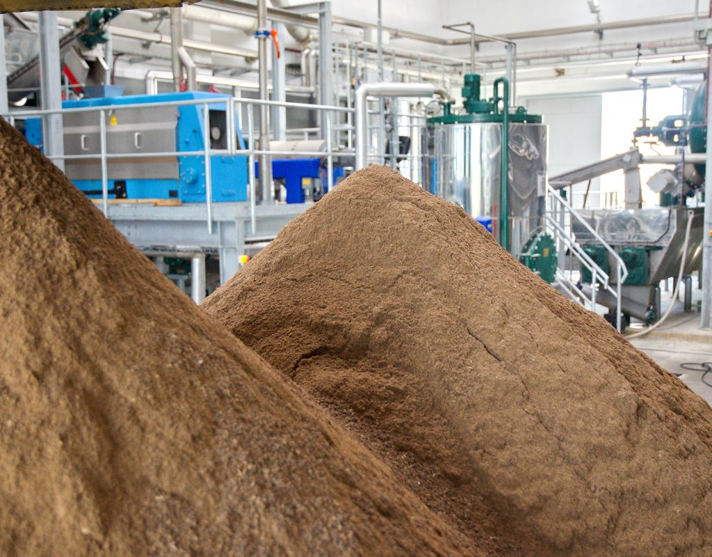 A pile of bone meal next to the equipment used to make it