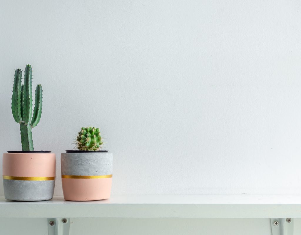 A pair of cute grey and coral handmade planters