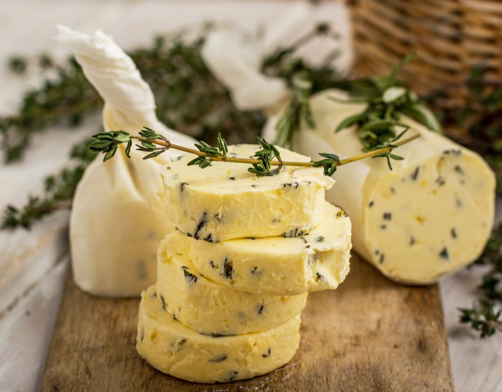 A sliced roll of homemade herb butter