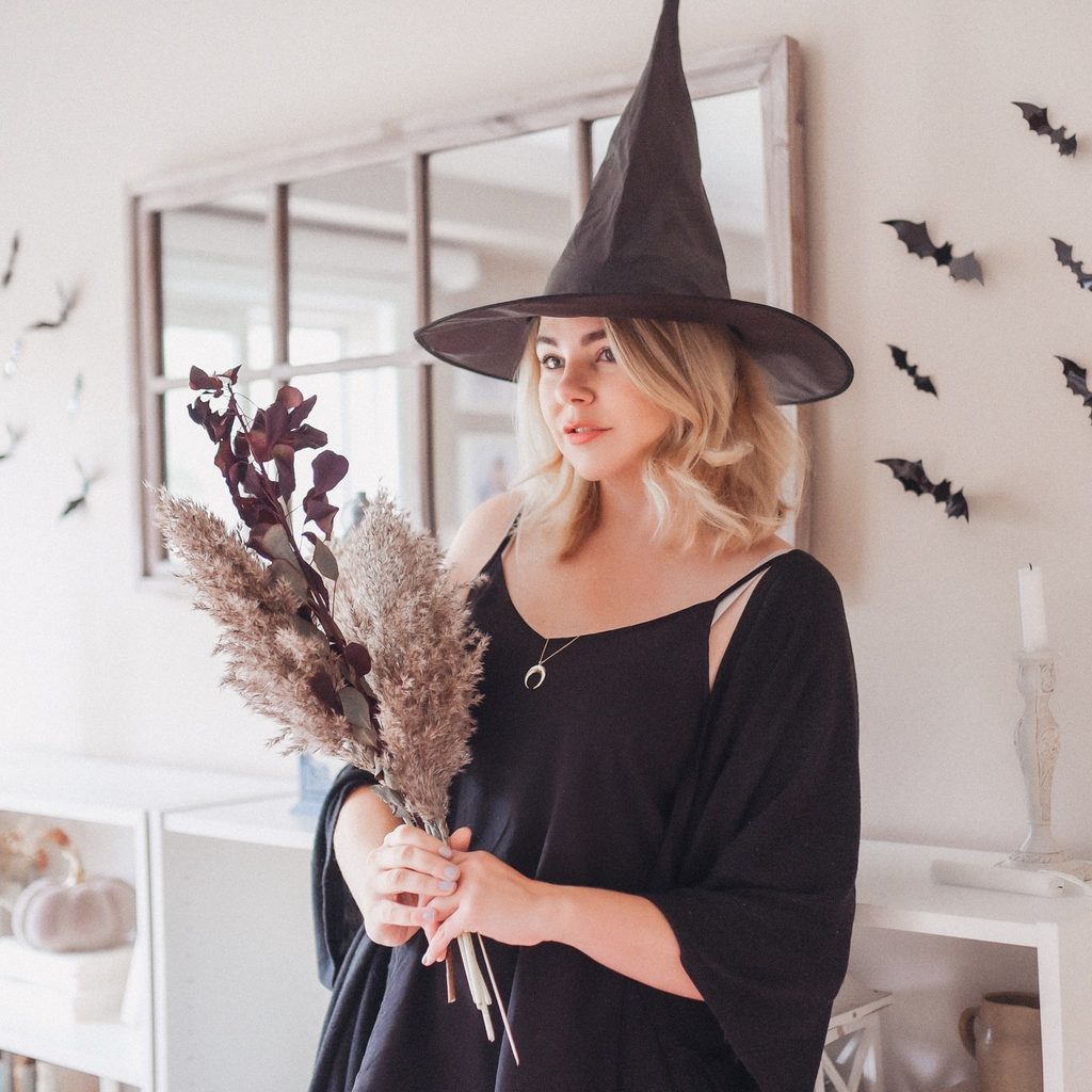 girl dressed as witch with flowers