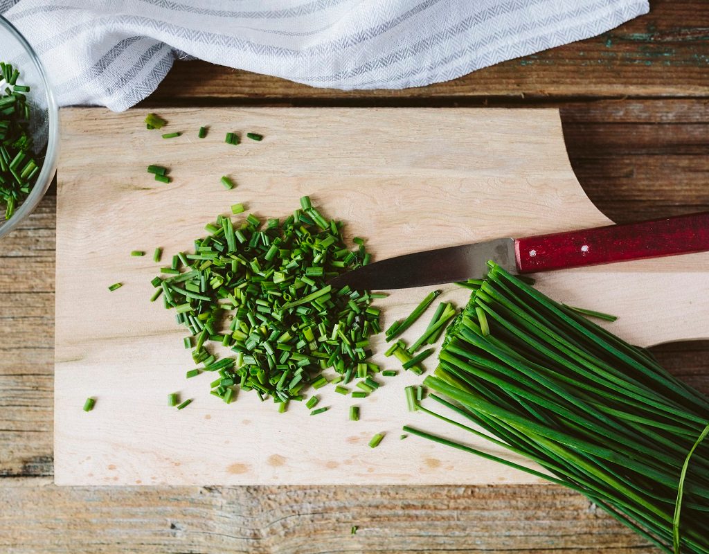 Chopping chives on a cutting board