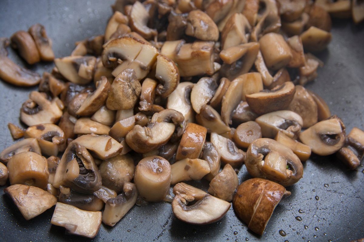A pan full of sauteed cremini mushroom chunks