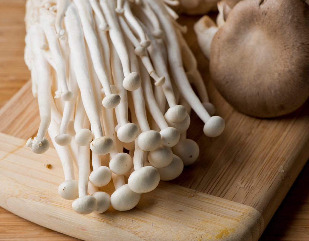Enoki mushrooms on a cutting board