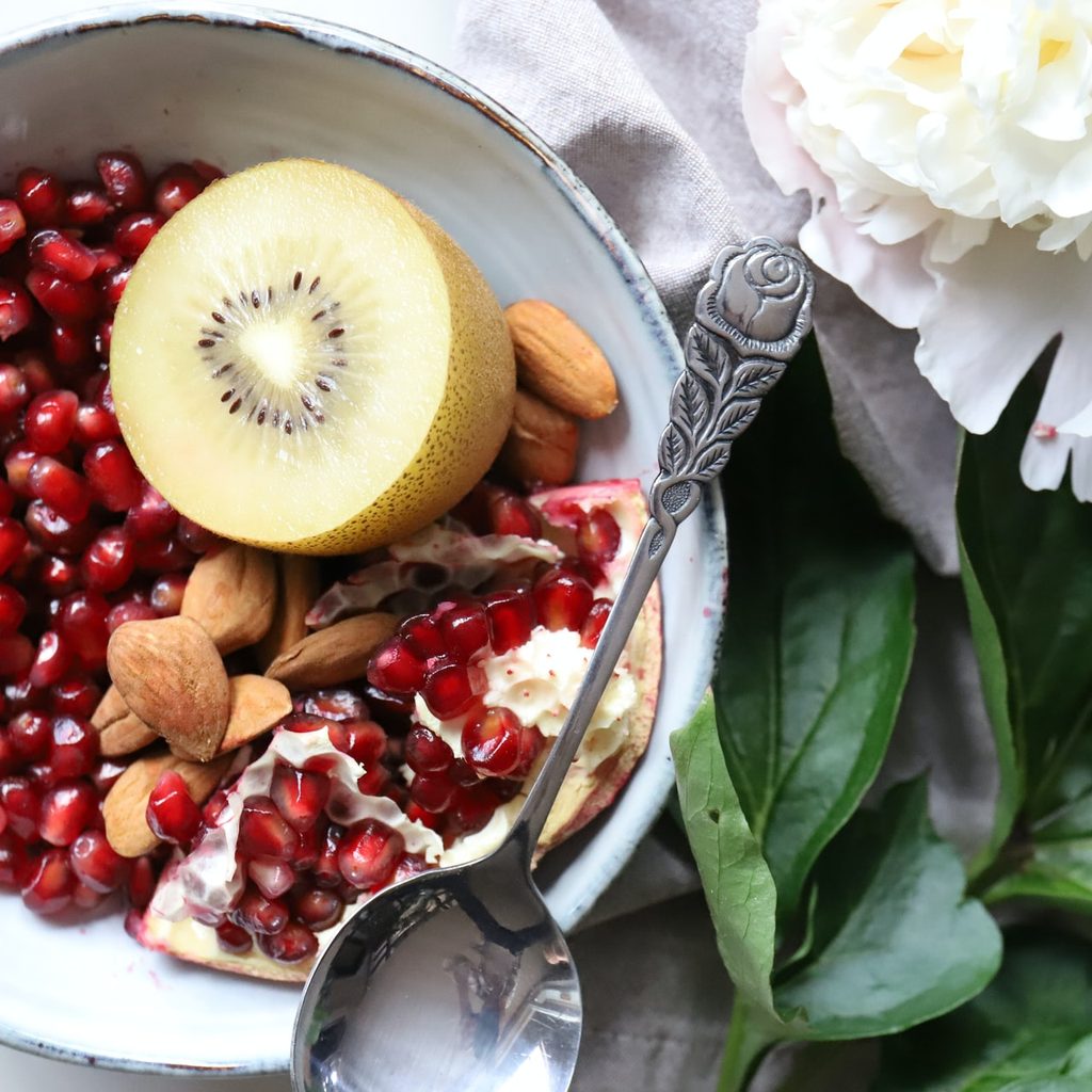 kiwi and pomegranate in a bowl