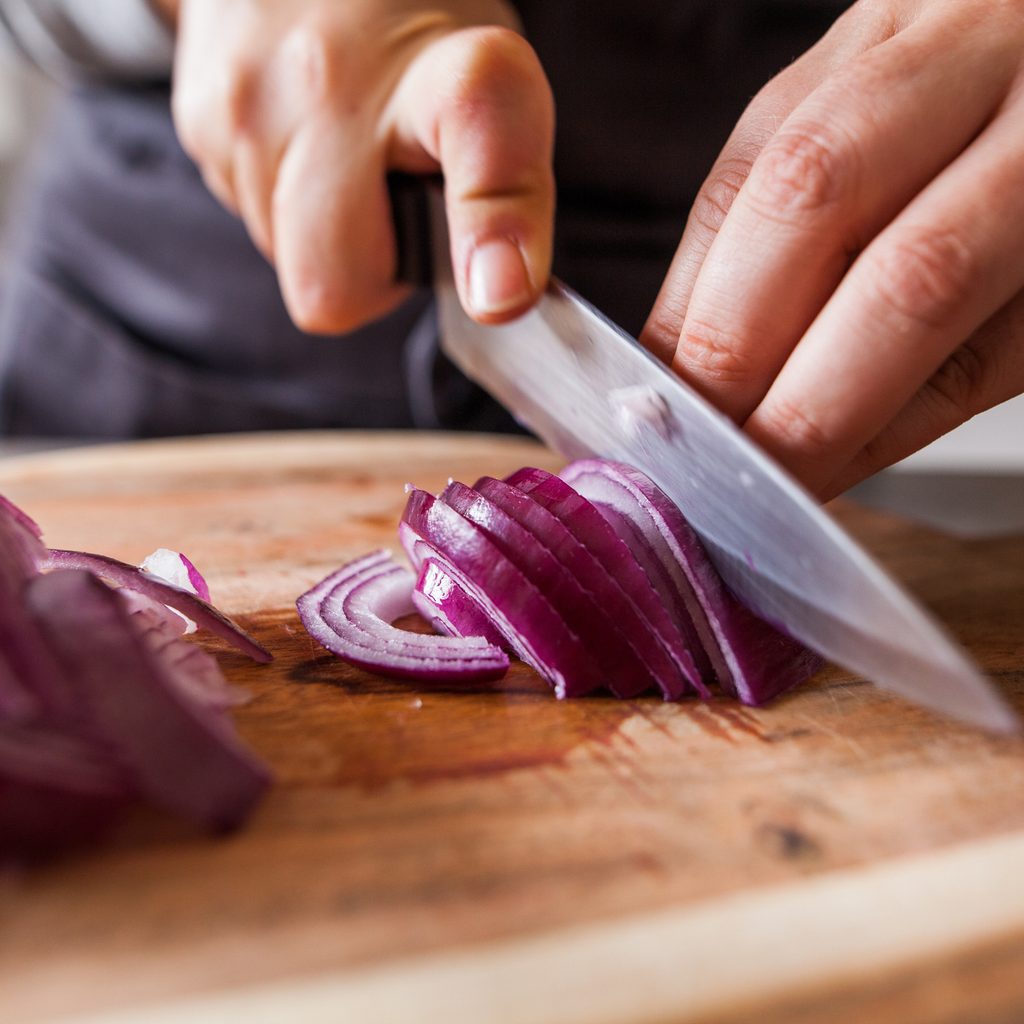 Chopping onion with knife