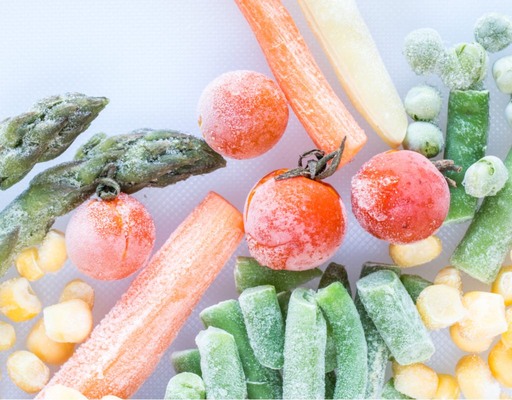 An assortment of frozen vegetables against a white background