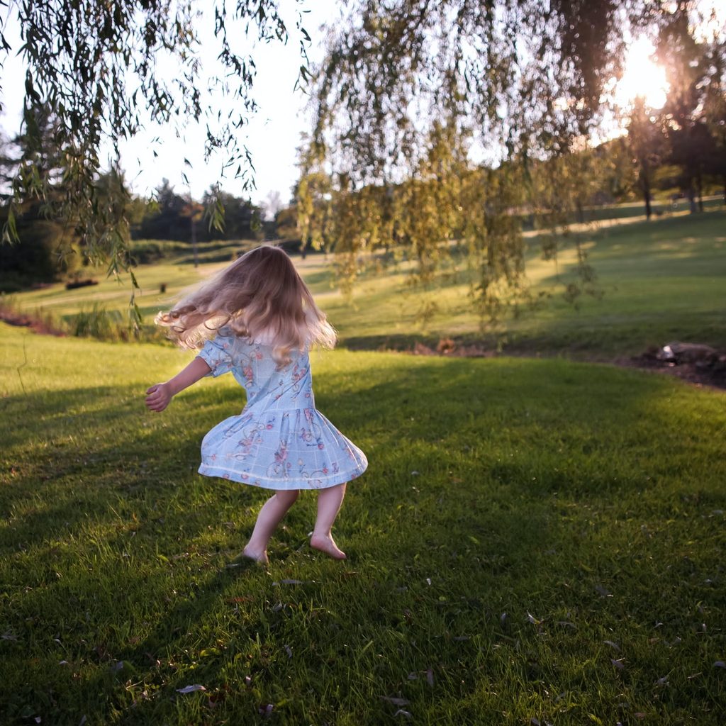 Child playing in grass