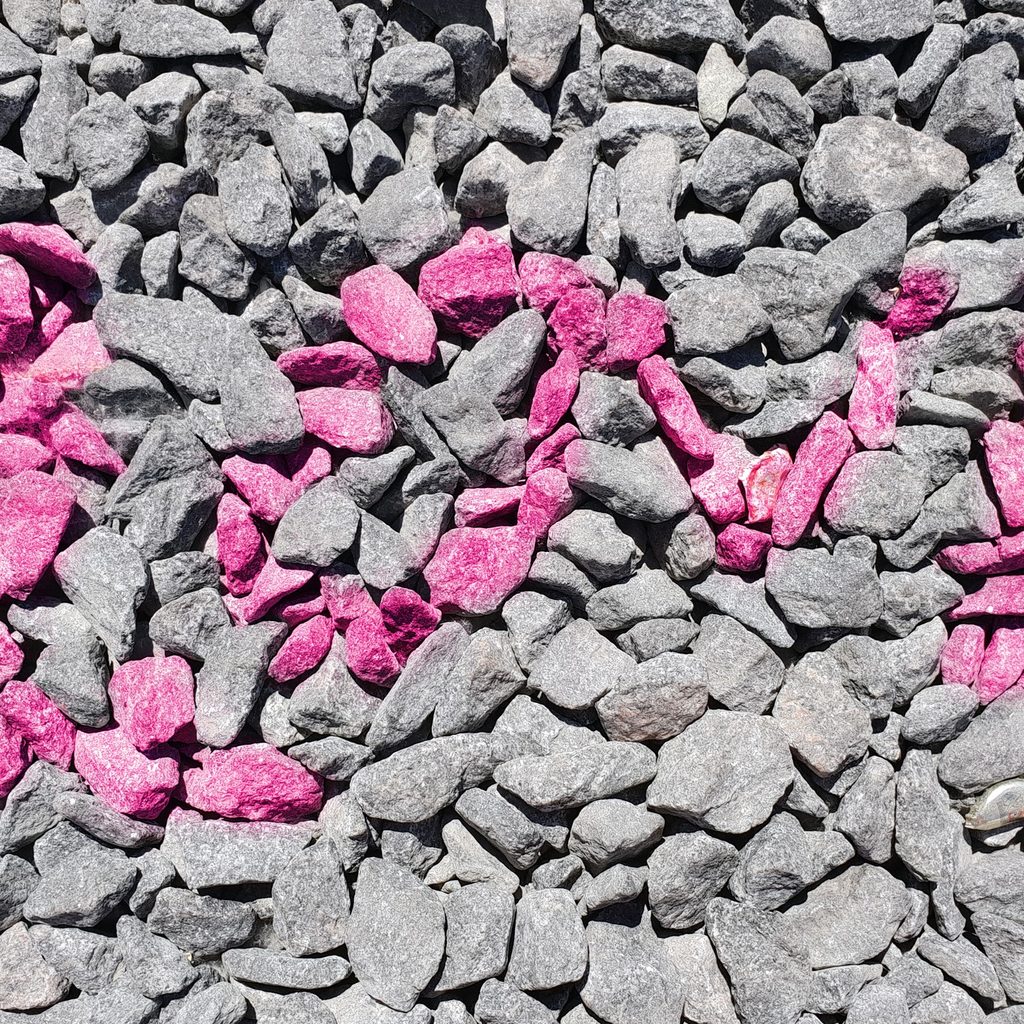 Pink rocks spelling "LOVE" with gray rocks surrounding it
