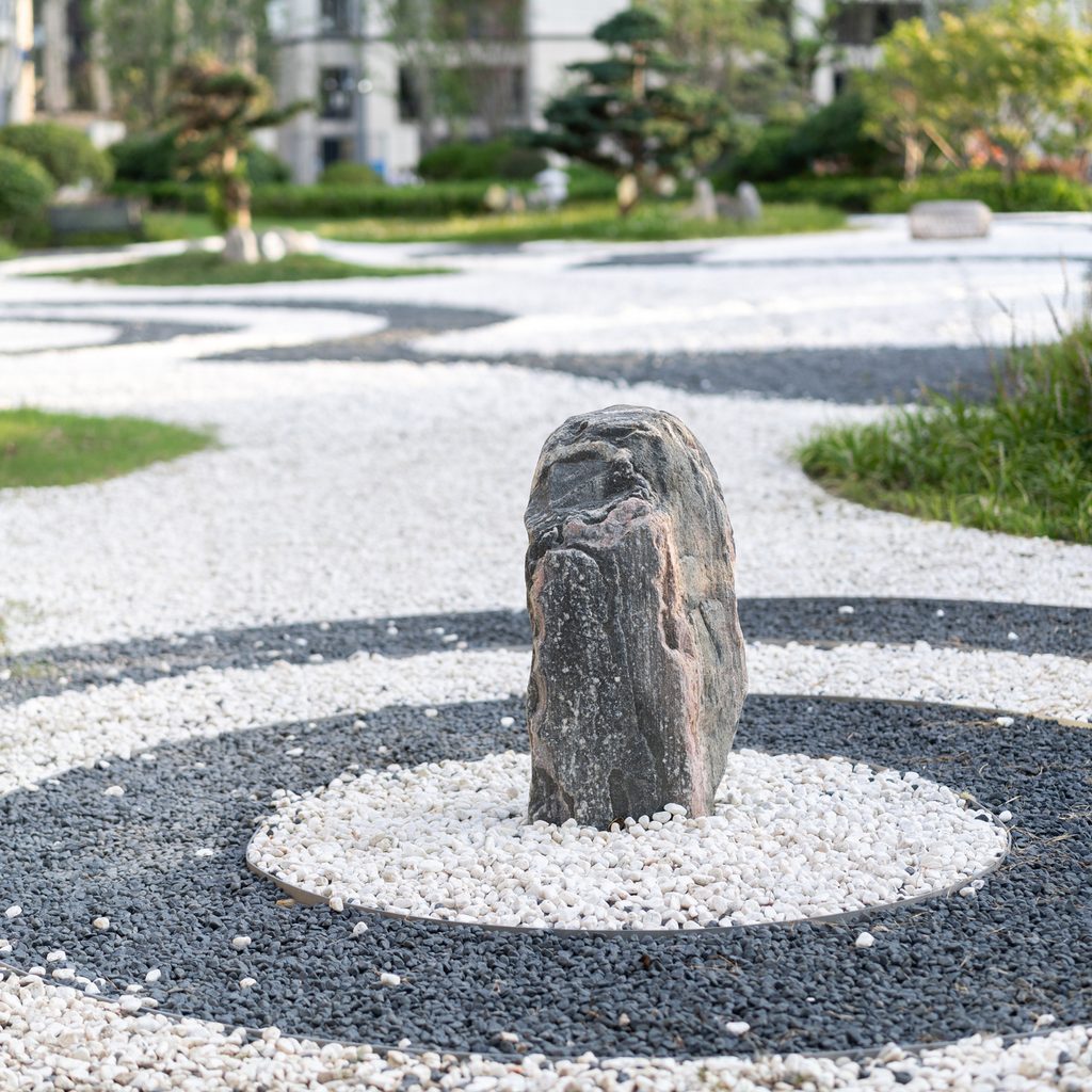 Black and white stone circles surrounding a tall rock