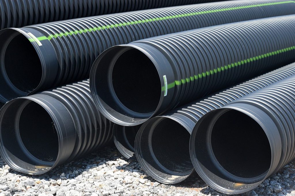 A pile of corrugated drain pipes