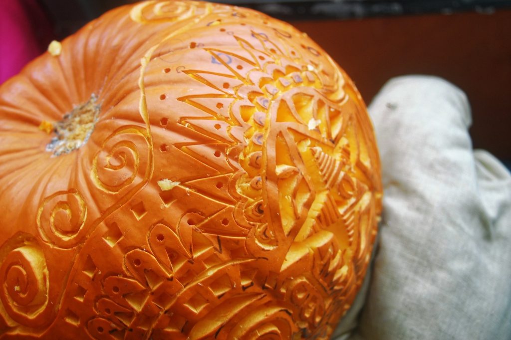 A pumpkin with an intricate pattern carved into it