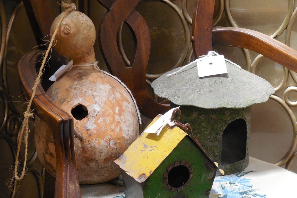 Three birdhouses, one made out of a dried gourd
