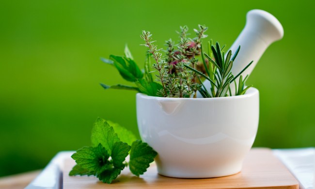 Bowl of medicinal herbs on a wooden board