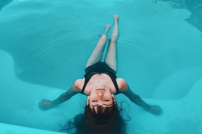 Woman in black swimsuit in a pool