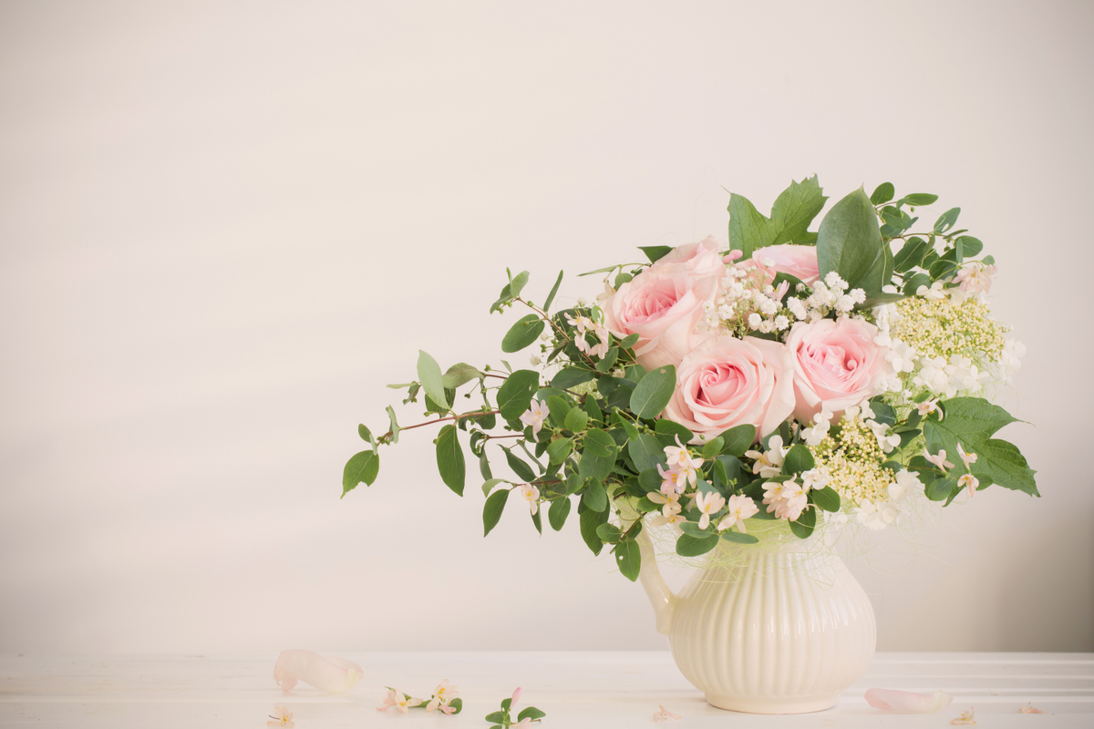 An arrangement of light roses and greenery