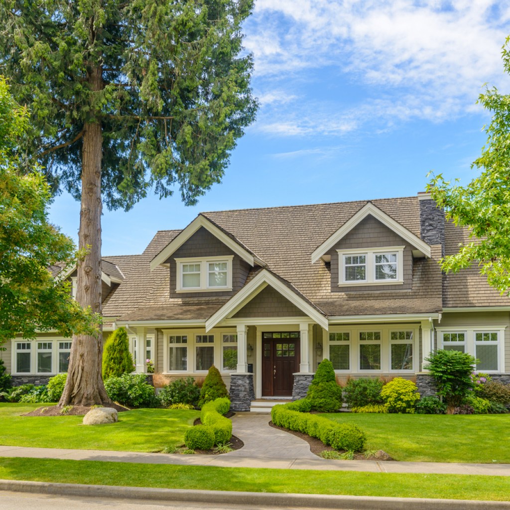 street view of a gray house with manicured landscape