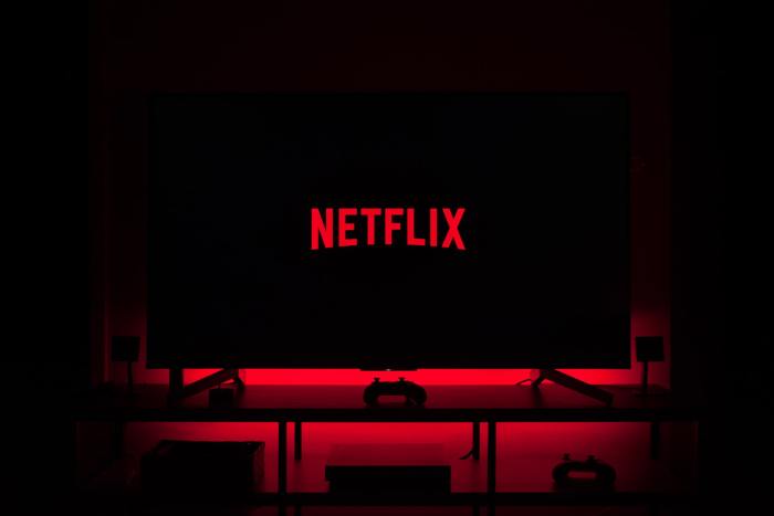 Netflix logo on TV in red lit room