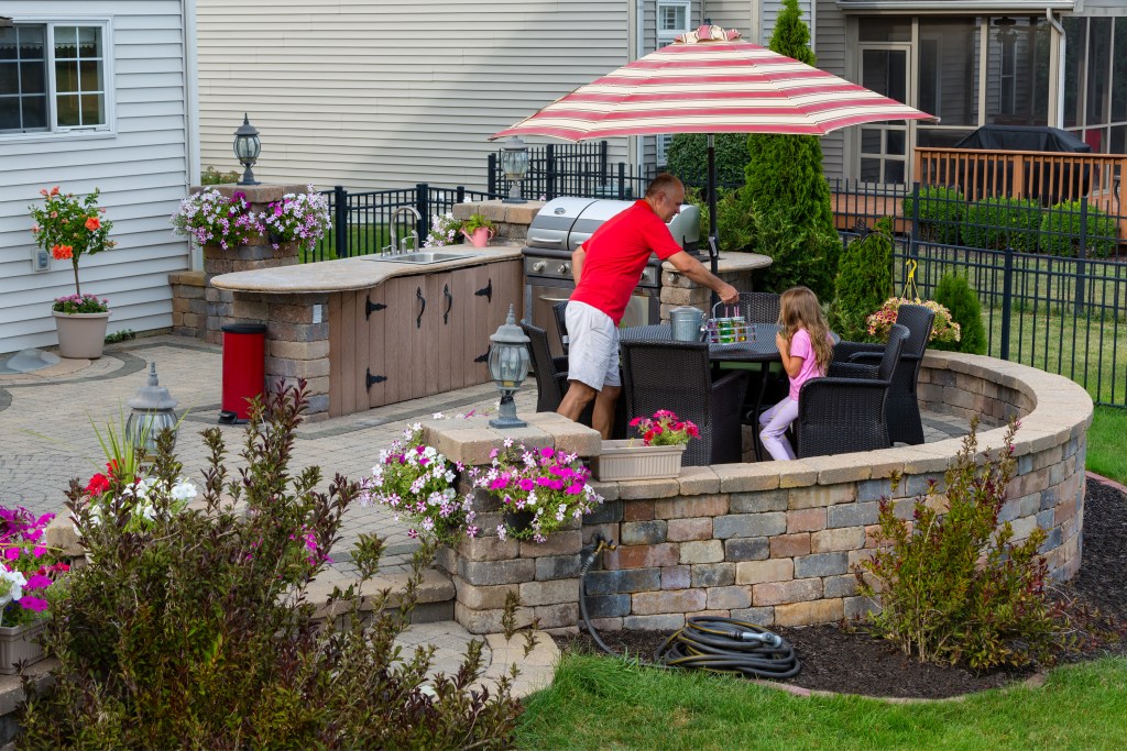 Family enjoying a meal in their outdoor kitchen