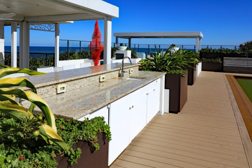 Beautiful granite countertop on a white cabinet located on an oceanfront outdoor terrace in a South Florida condominium.