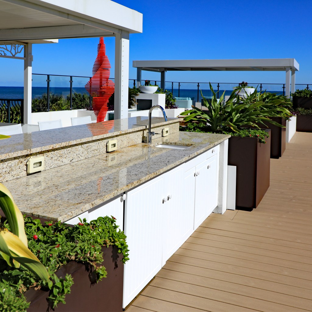 Beautiful granite countertop on a white cabinet located on an oceanfront outdoor terrace in a South Florida condominium.