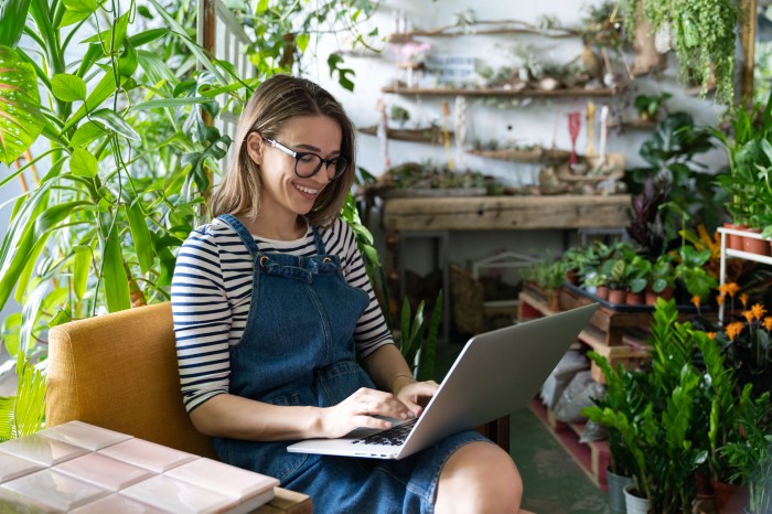 Person on computer next to plants