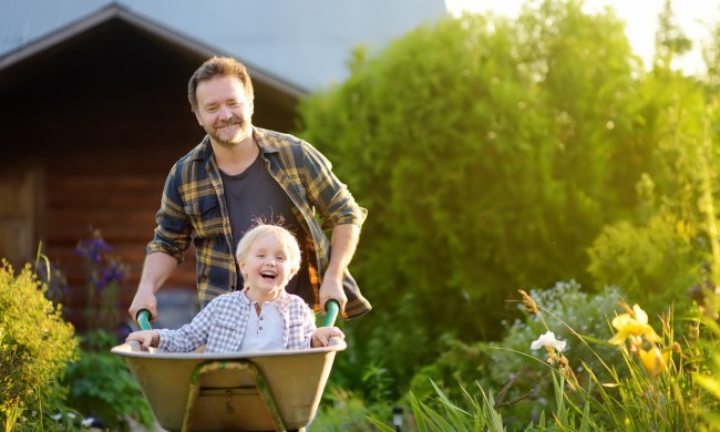 Parent and child having fun by garden