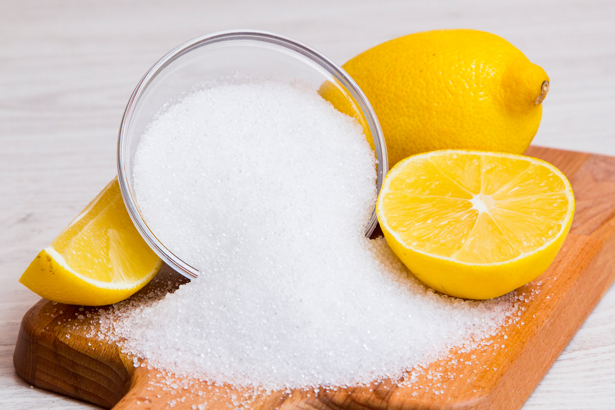 lemons and crystalized citric acid on a cutting board