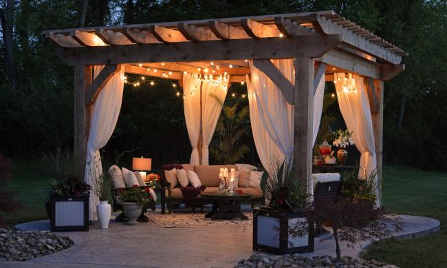 A patio at night decorated and lit by string lights
