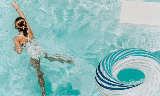 Girl in pool with diving board