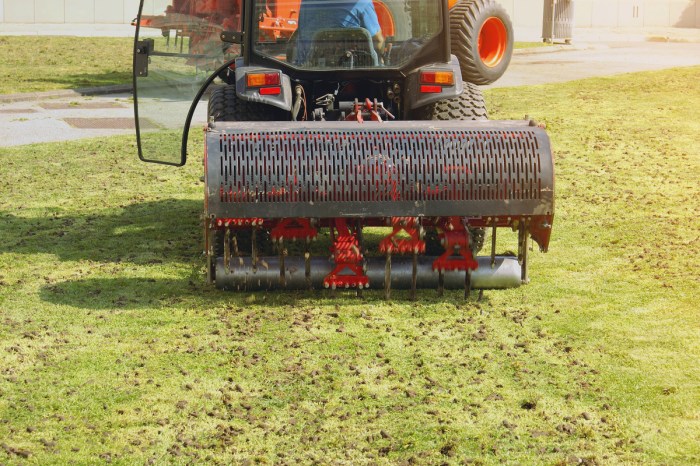 Ride-on core aerator working on a lawn