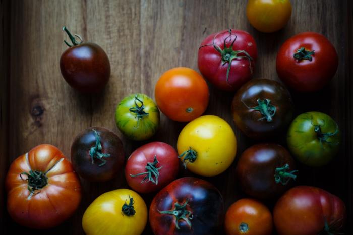 Assorted heirloom tomatoes on a wooden background